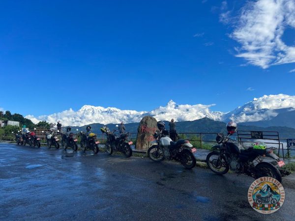Royal Enfield riders crossing Kali Gandaki Gorge during motorbike adventure in Mustang